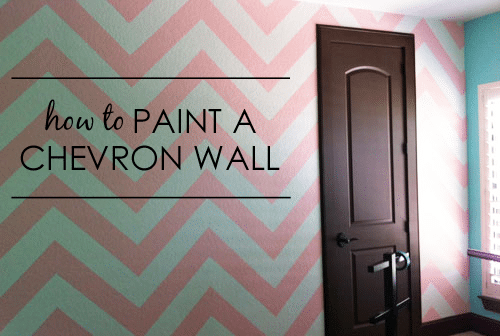 pink and blue painted chevron wall with brown door