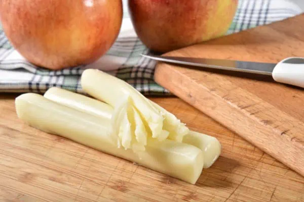 cheese strings on cutting board