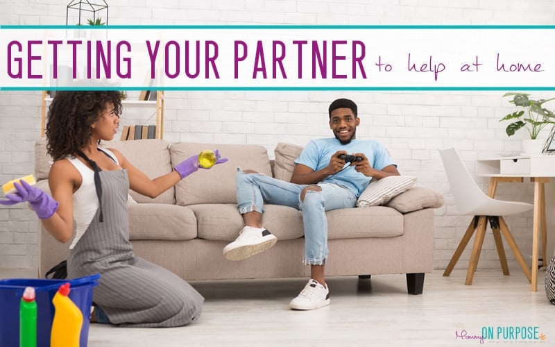 woman cleaning while man plays video games - text reads getting your partner to help at home
