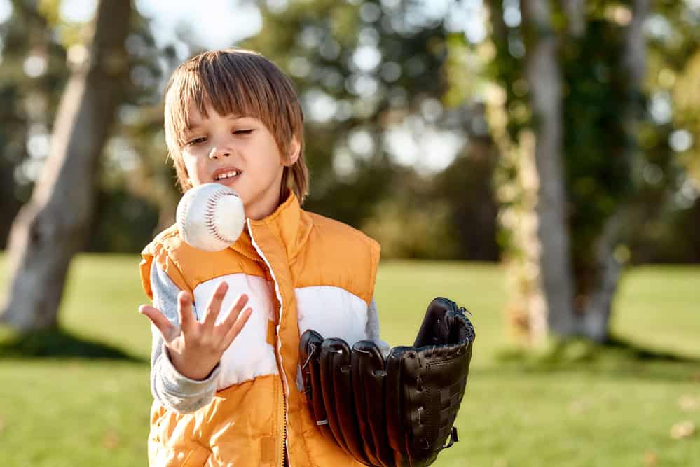 kid playing baseball sports in the backyard