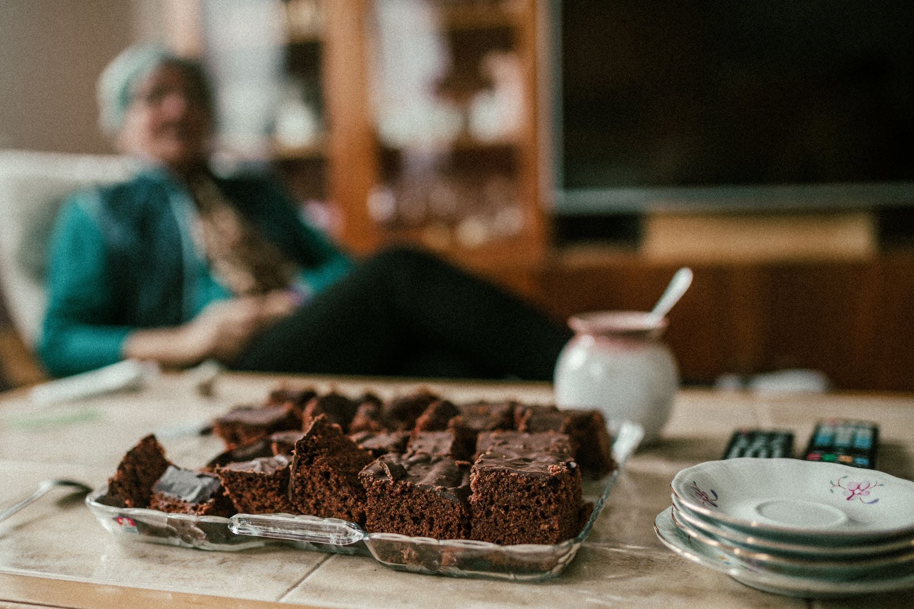 Freshly baked chocolate brownies on a table with a cozy indoor setting, ideal for lifestyle themes.